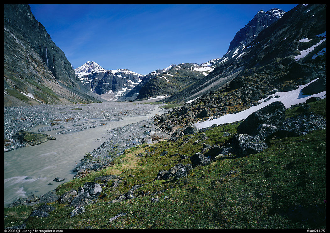 Stream and distant waterfall in valley below Telaquana Mountains. Lake Clark National Park, Alaska, USA.