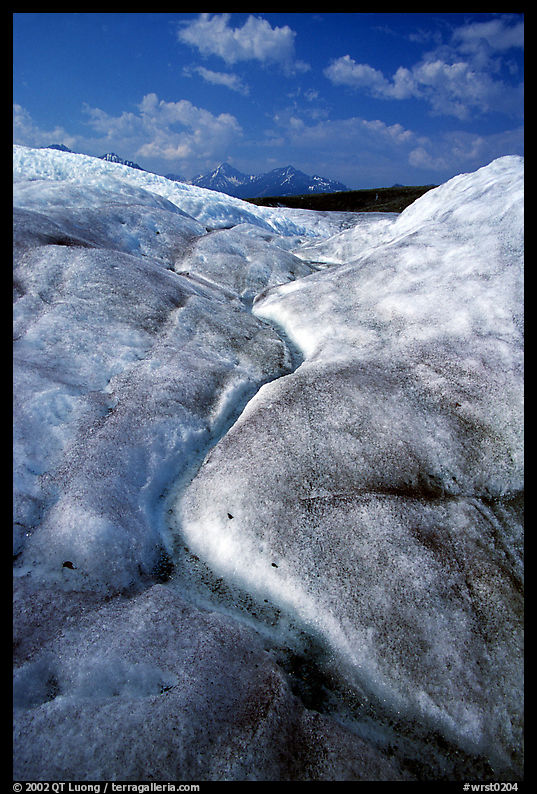 Ice, glacial creek on Root glacier, and mountains. Wrangell-St Elias National Park