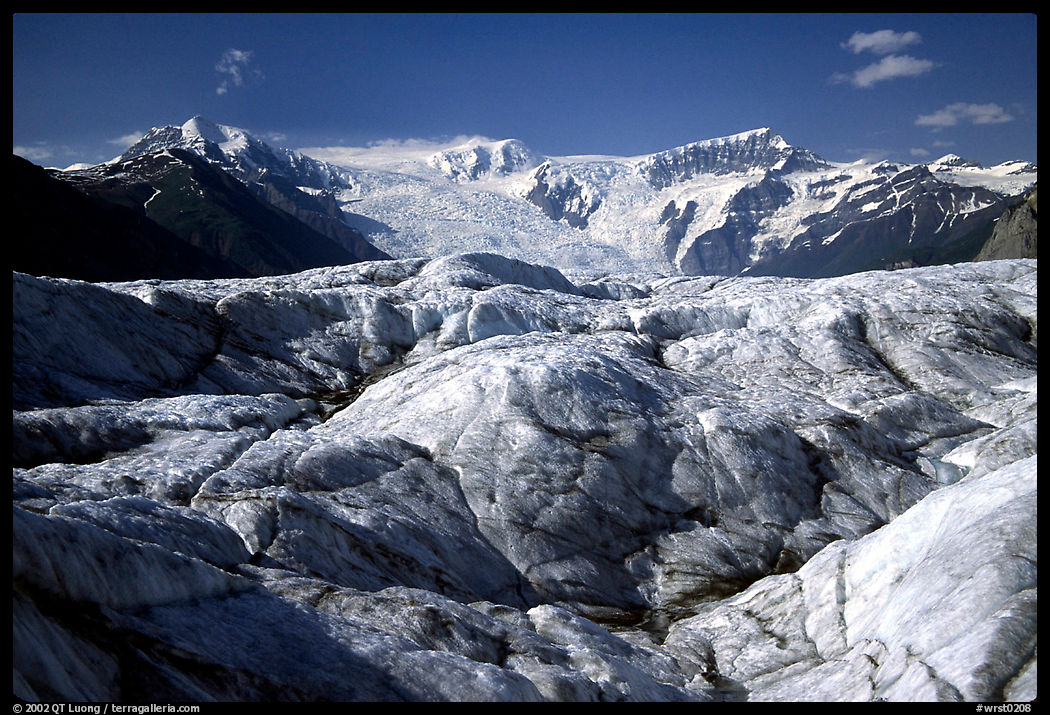Crevasses on Root glacier, Wrangell mountains in the background. Wrangell-St Elias National Park, Alaska, USA.