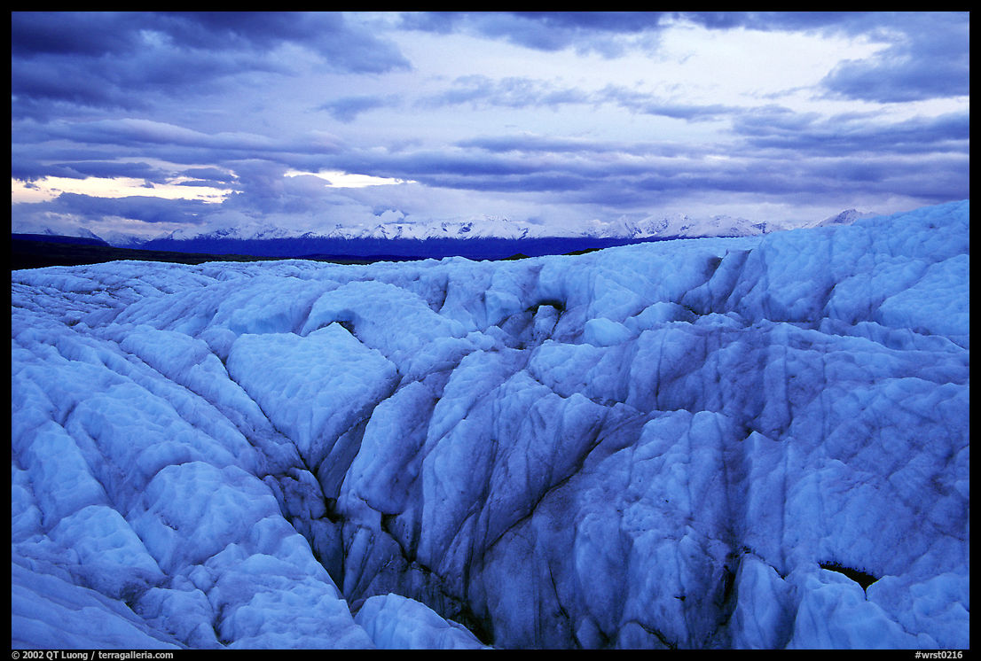 Crevasses on Root glacier at dusk, Chugach mountains in the background. Wrangell-St Elias National Park, Alaska, USA.