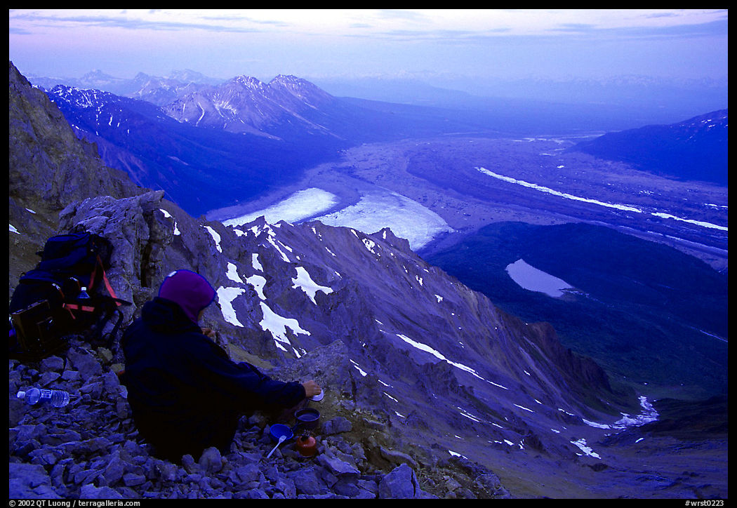 Mountaineer looking down from Mt Donoho. Wrangell-St Elias National Park, Alaska, USA.