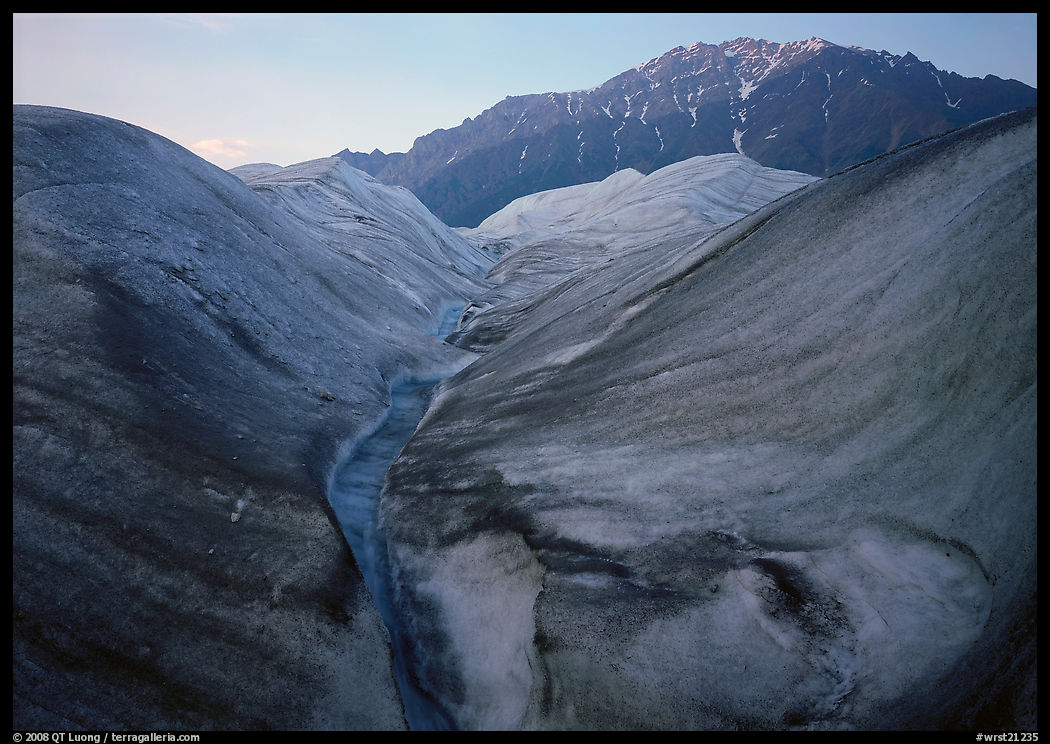 Root Glacier, glacial stream, and mountains at dusk. Wrangell-St Elias National Park, Alaska, USA.