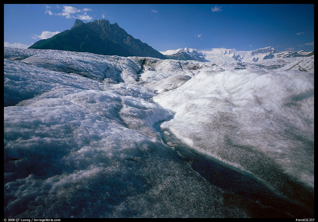 Stream running on surface of Root Glacier and Mt Donoho. Wrangell-St Elias National Park, Alaska, USA.