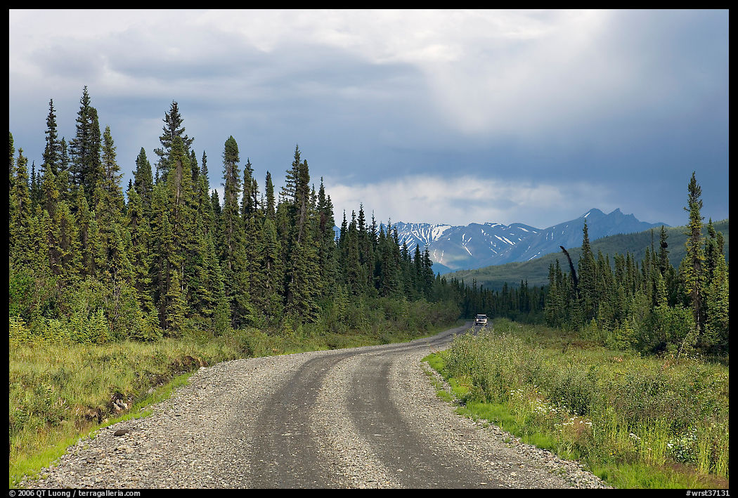 McCarthy road with vehicle approaching in the distance. Wrangell-St Elias National Park, Alaska, USA.