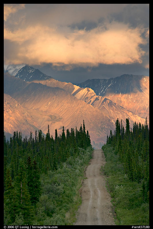 Road leading to mountains and clould lit by sunset light. Wrangell-St Elias National Park, Alaska, USA.