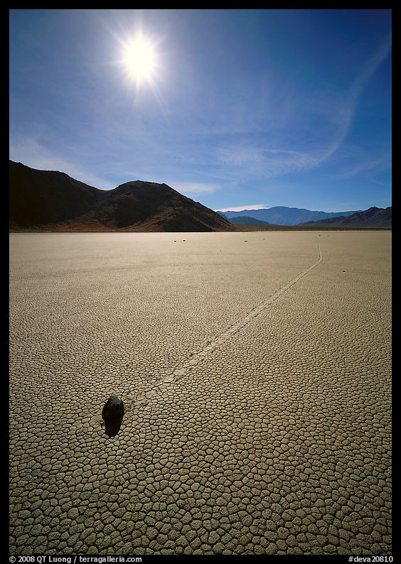 Tracks and moving rock on the Racetrack, mid-day. Death Valley National Park, California, USA.