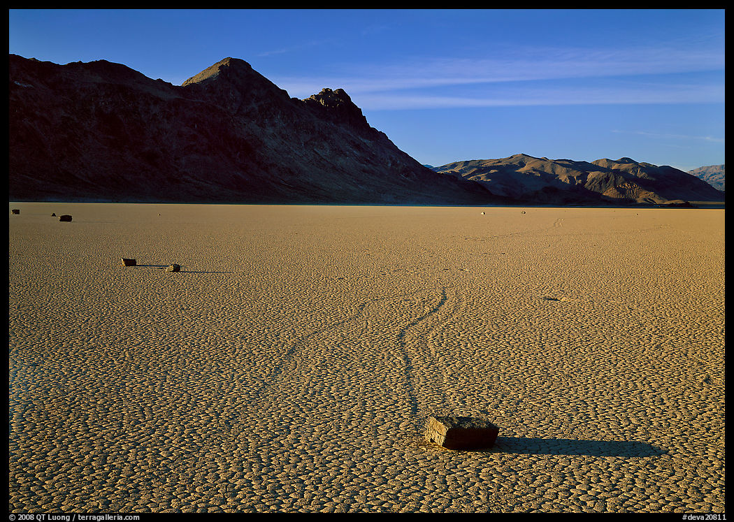 Tracks, moving stone on Racetrack playa and Ubehebe Peak, late afternoon. Death Valley National Park, California, USA.