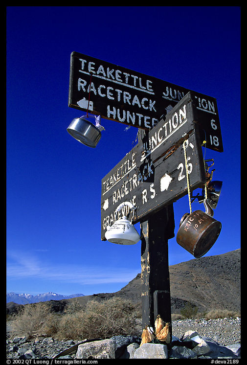 Tea kettle Junction sign, adorned with tea kettles. Death Valley National Park, California, USA.