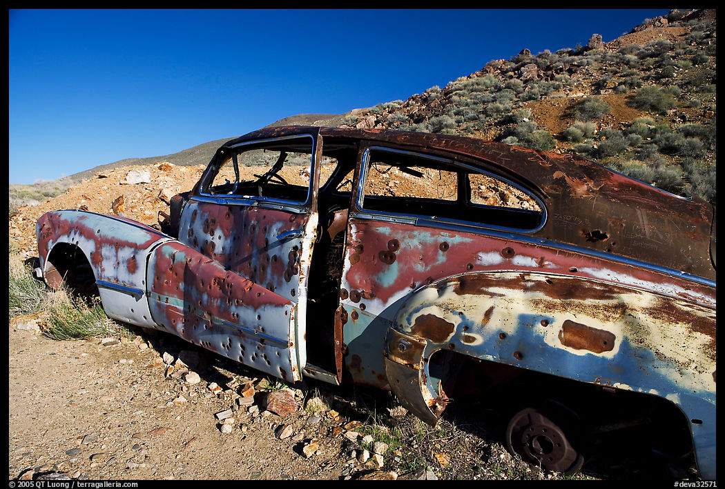 Car with bullet holes near Aguereberry camp, afternoon. Death Valley National Park, California, USA.