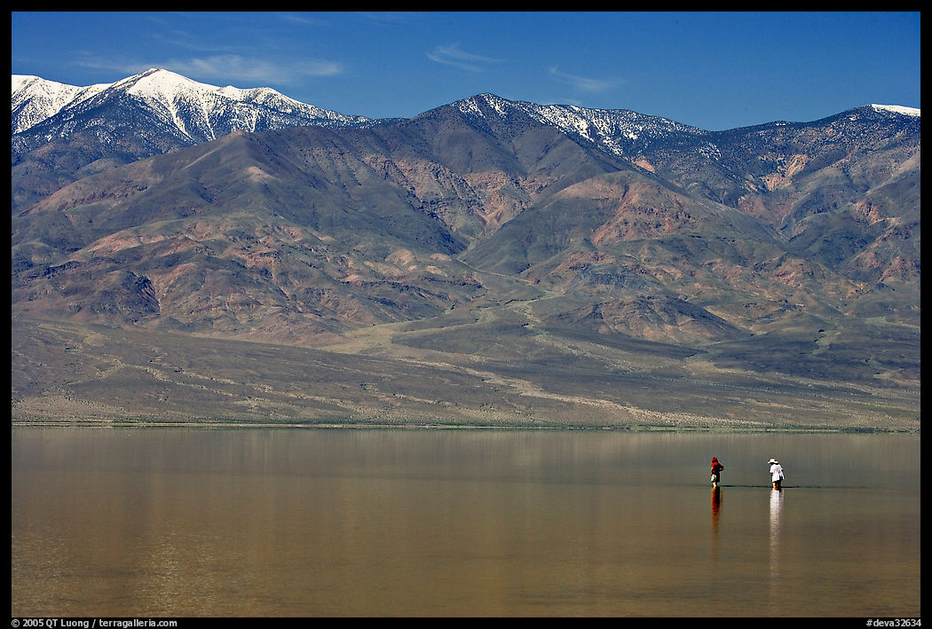 Visitors wading in the rare seasonal lake. Death Valley National Park, California, USA.