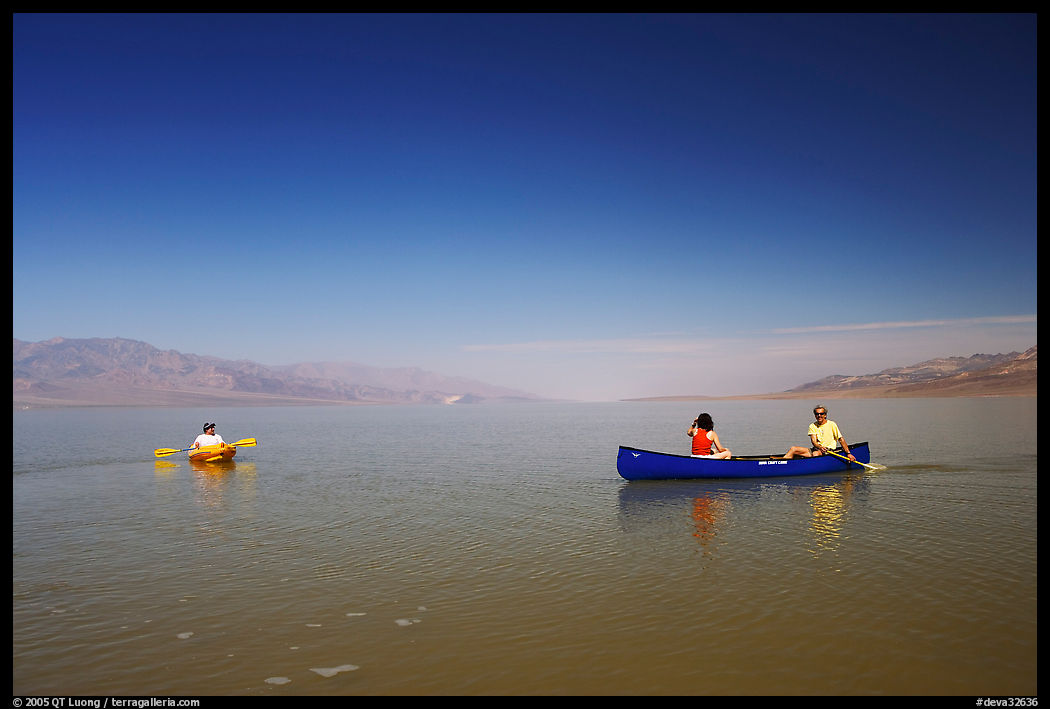Canoists and kayaker on the flooded floor. Death Valley National Park, California, USA.
