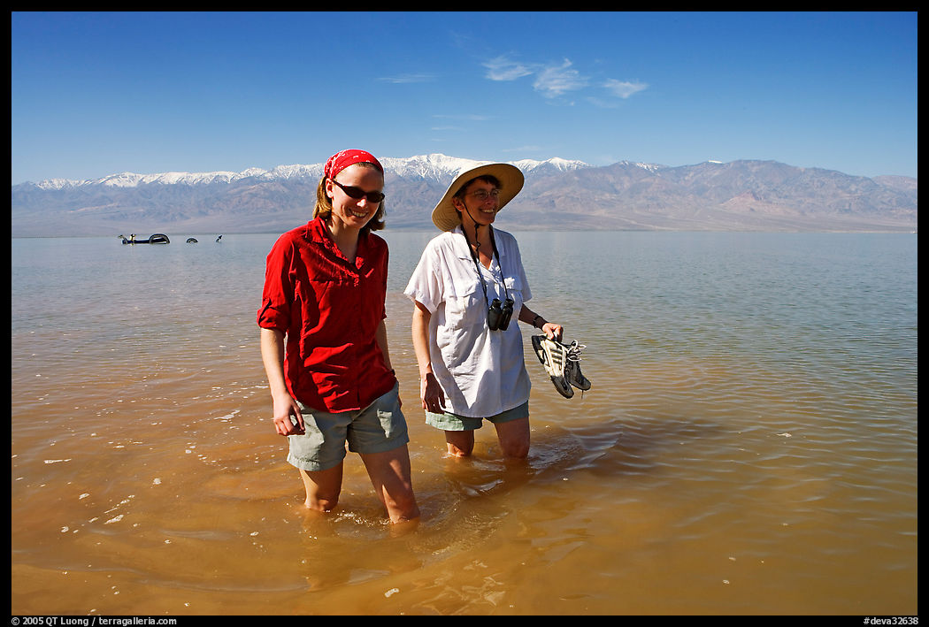 Women wading in the knee-deep seasonal lake. Death Valley National Park, California, USA.