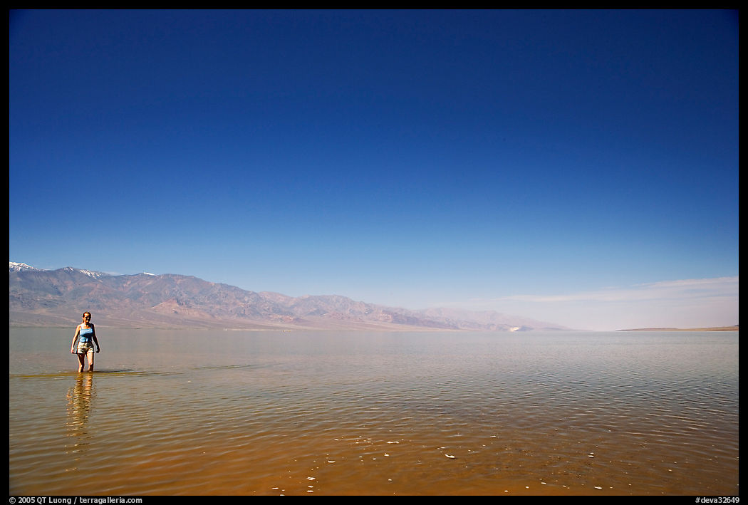 Woman wading in Manly Lake. Death Valley National Park, California, USA.