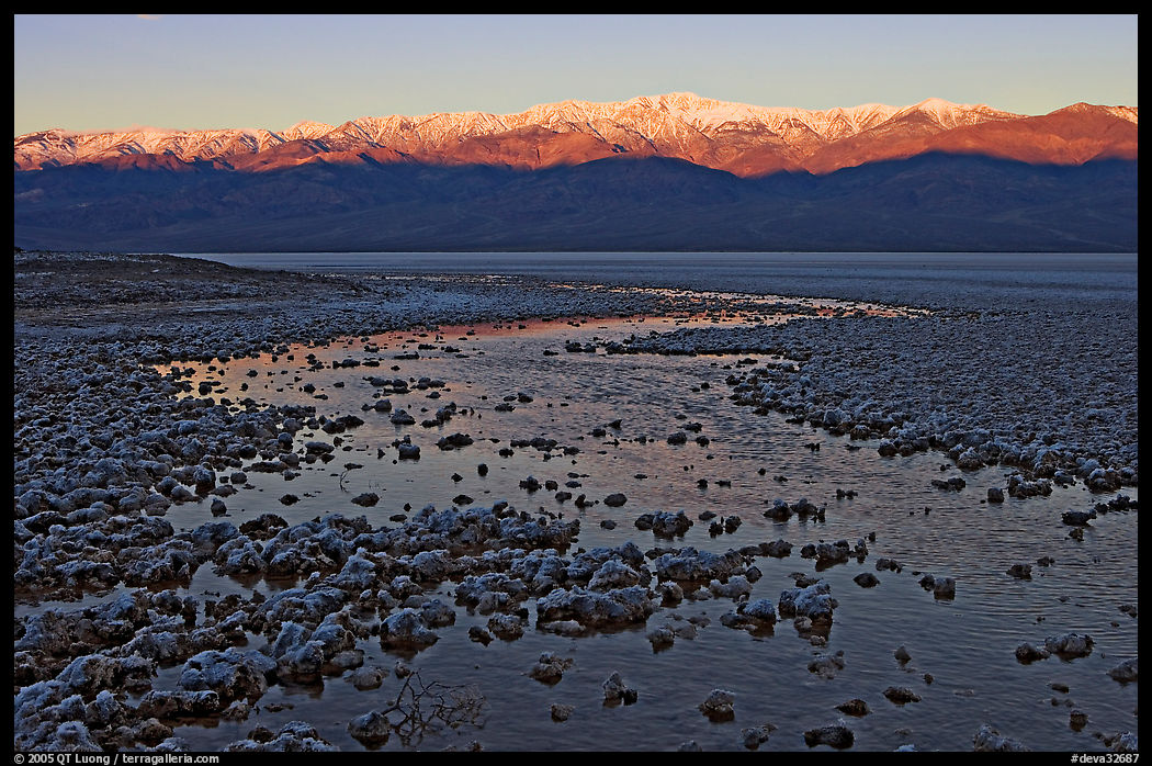 Salt pool and sunrise over the Panamints. Death Valley National Park, California, USA.
