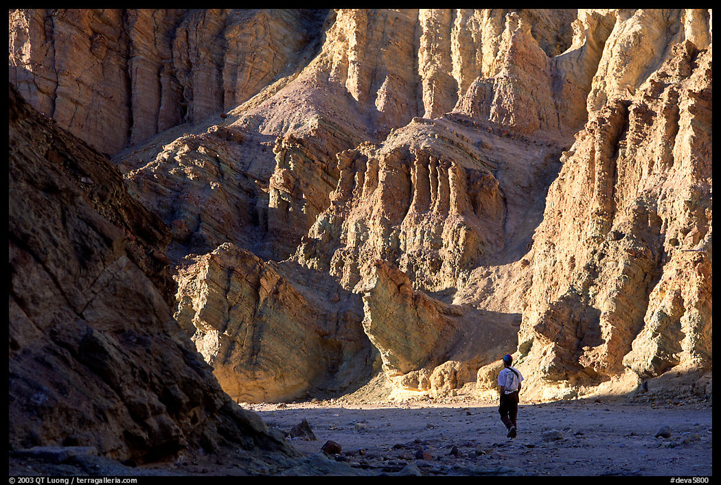 Hikers surrounded by tall walls in Golden Canyon. Death Valley National Park