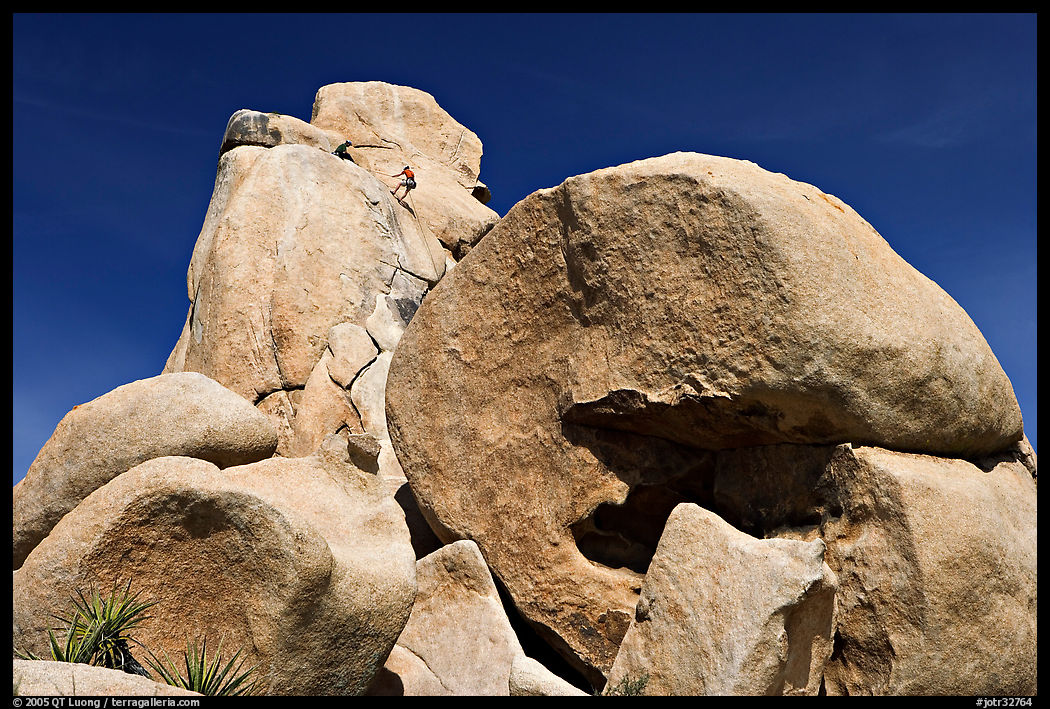 Rocks with climbers in a distance. Joshua Tree  National Park, California, USA.