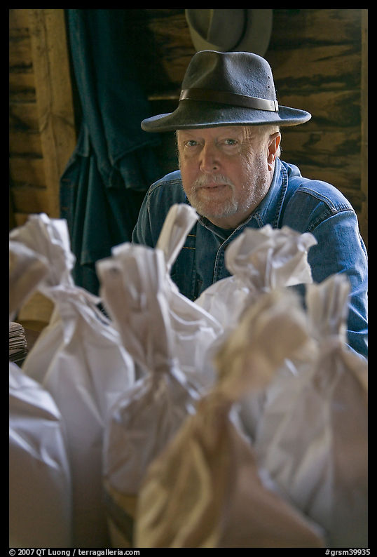 Miller sitting behind bags of cornmeal, North Carolina. Great Smoky Mountains National Park, USA.