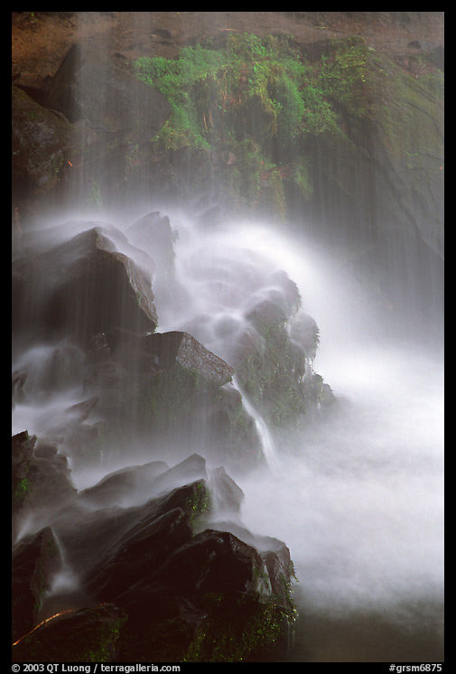 Misty water falling on dark rocks, Grotto falls, Tennessee. Great Smoky Mountains National Park, USA.