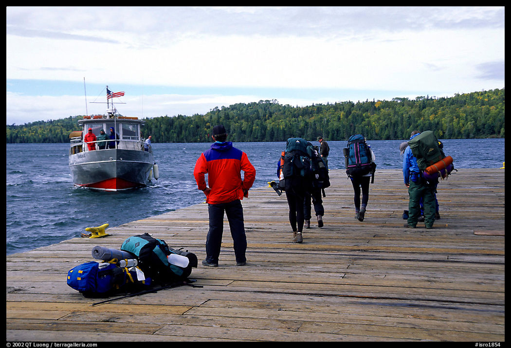 Backpackers waiting for pick-up by the ferry at Windego. Isle Royale National Park, Michigan, USA.
