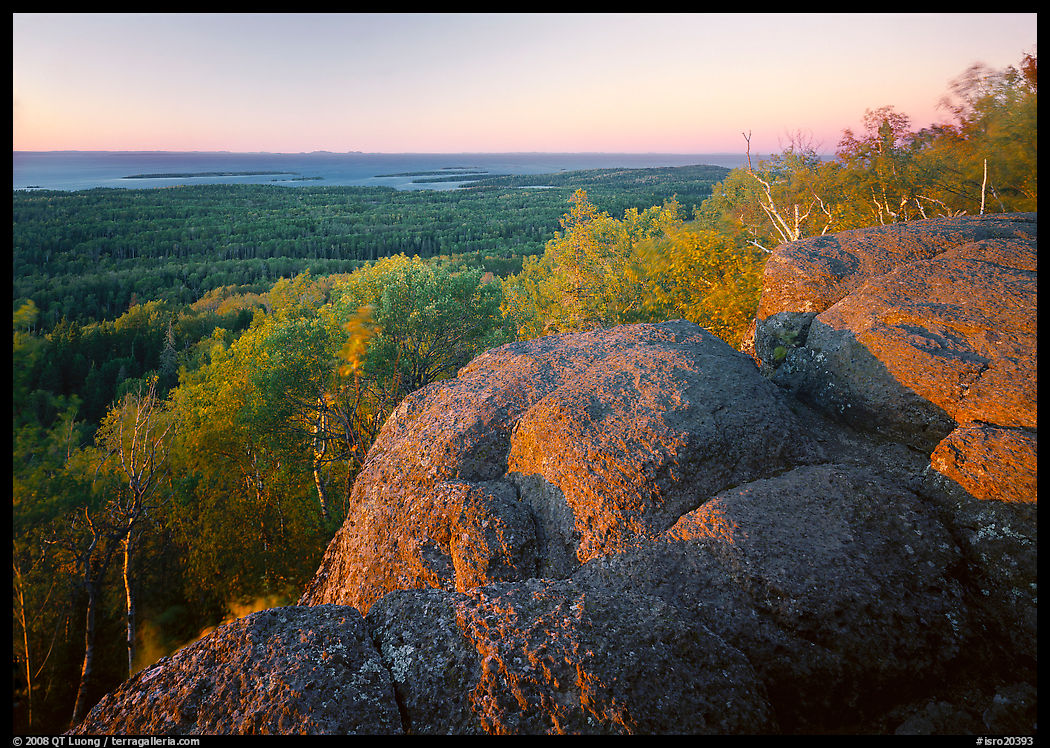 Mount Franklin granite outcrop and distant Lake Superior at sunset. Isle Royale National Park, Michigan, USA.