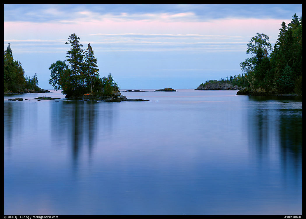 Tree-covered islet and smooth waters, Chippewa Harbor. Isle Royale National Park, Michigan, USA.
