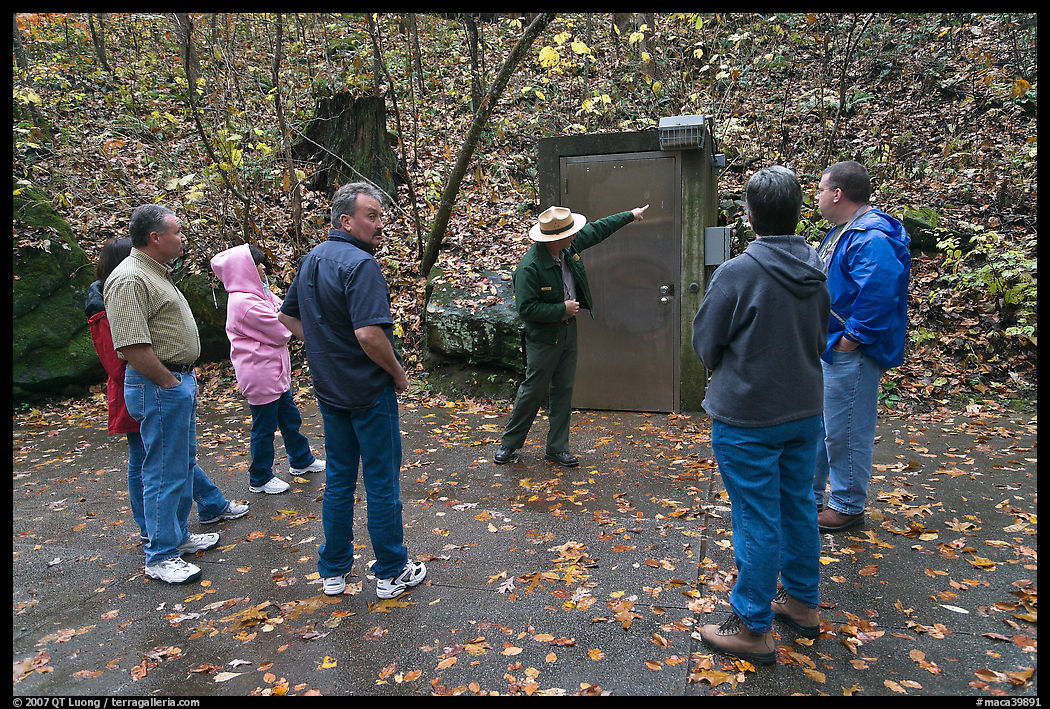 Ranger pointing to cave entrance to visitors. Mammoth Cave National Park, Kentucky, USA.