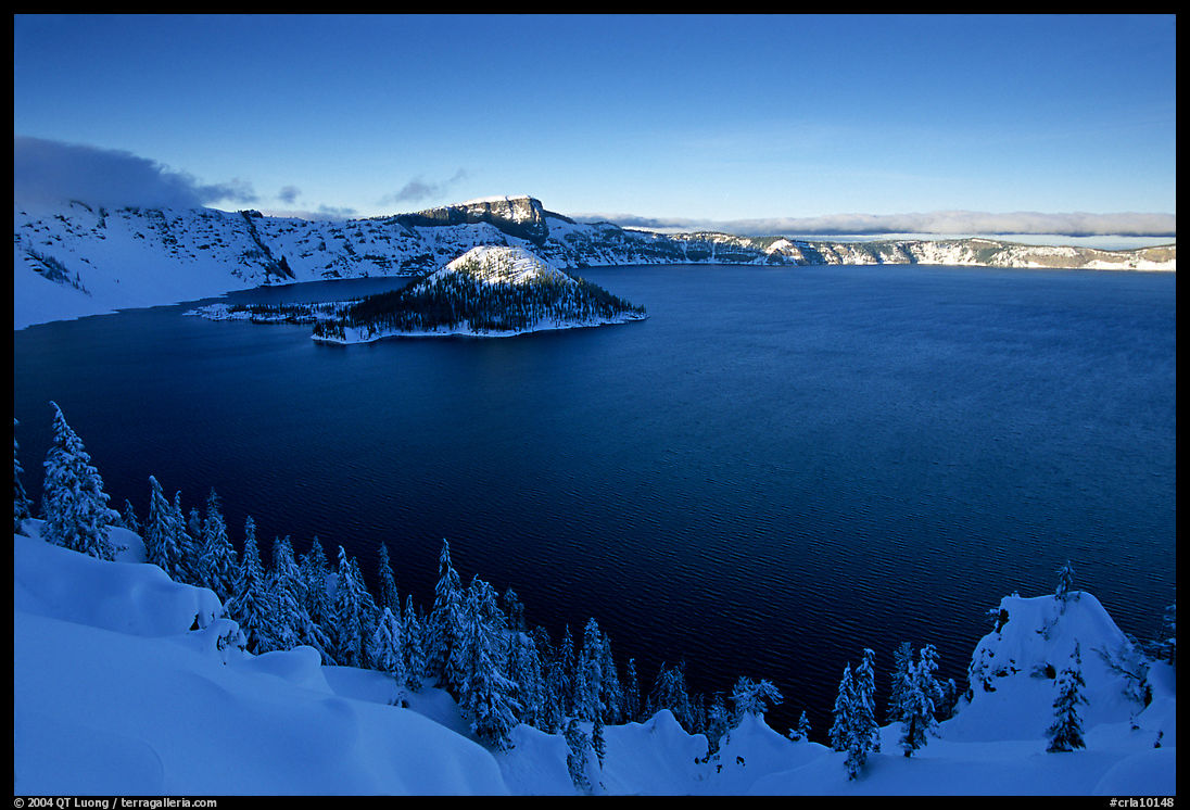 Wizard Island and lake in late afternoon shade, winter. Crater Lake National Park, Oregon, USA.