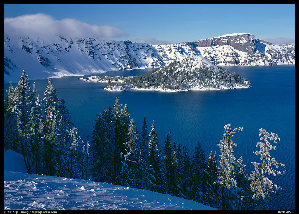 Lake and Wizard Island in winter, sunny afternoon. Crater Lake National Park, Oregon, USA.
