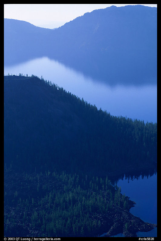 Wizard Island and crater rim profiles, early morning. Crater Lake National Park