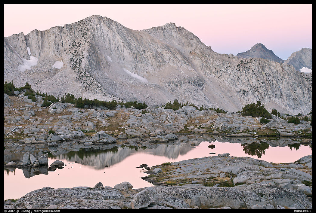 Mountains reflected in calm alpine lake at dawn, Dusy Basin. Kings Canyon  National Park, California, USA.