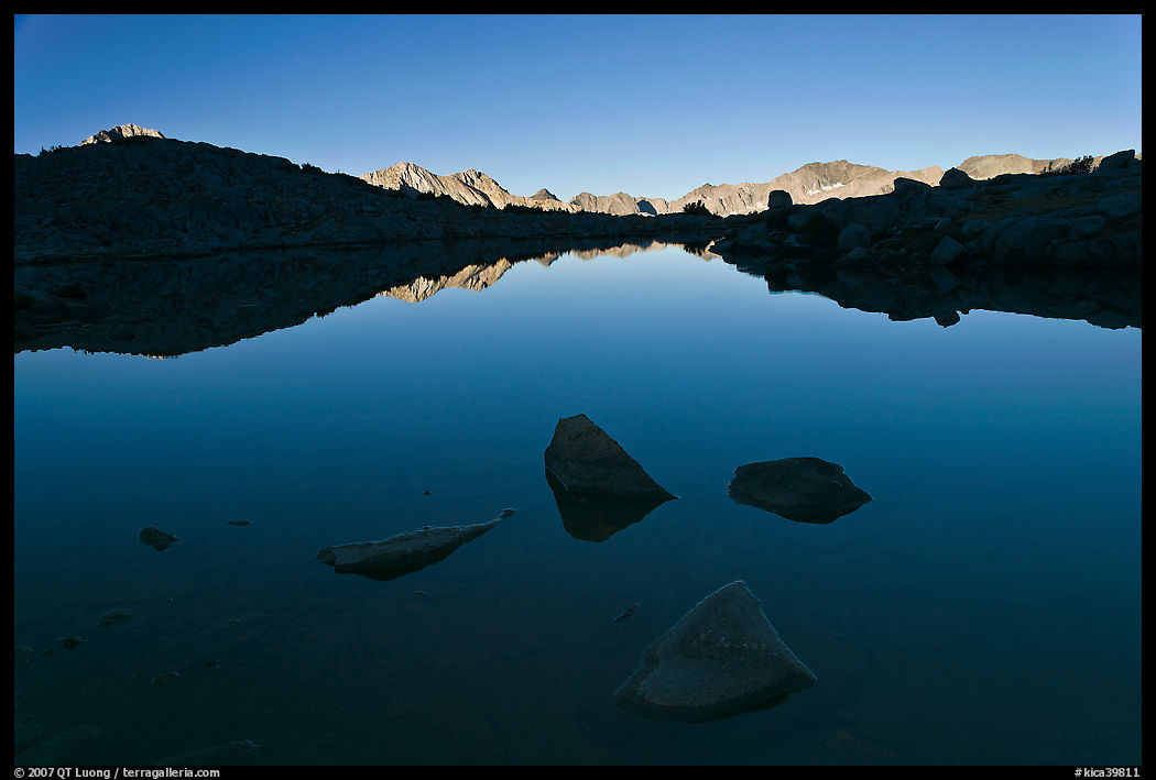 Rocks and calm lake with reflections, early morning, Dusy Basin. Kings Canyon  National Park, California, USA.