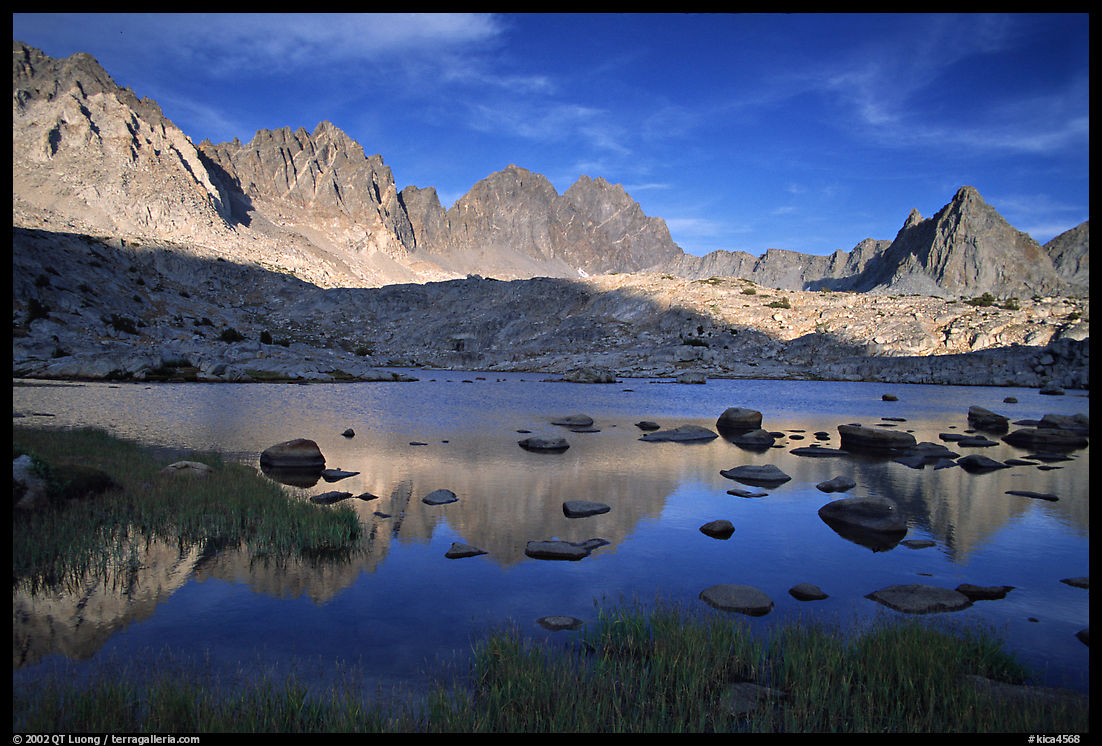 Mt Agasiz, Mt Thunderbolt, and Isoceles Peak reflected in a lake in Dusy Basin, late afternoon. Kings Canyon  National Park, California, USA.
