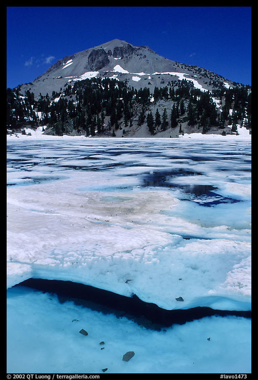 Ice break up in lake Helen and Lassen Peak, early summer. Lassen Volcanic National Park, California, USA.