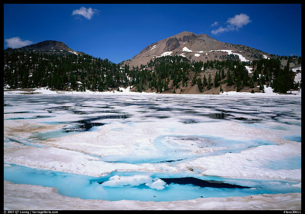 Helen Lake with Ice breaking up, and Lassen Peak. Lassen Volcanic National Park, California, USA.
