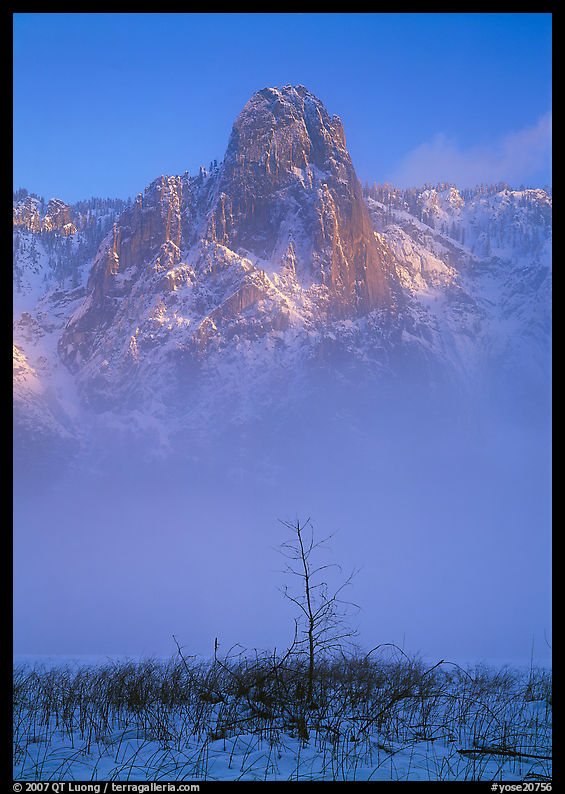 Sentinel rock rising above fog on valley in winter. Yosemite National Park, California, USA.