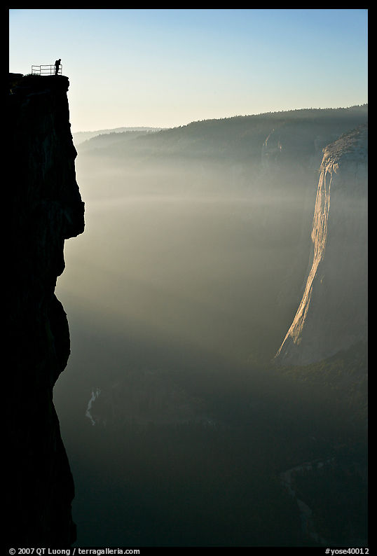 Hiker surveying Yosemite Valley from Profile Cliff overlook. Yosemite National Park, California, USA.