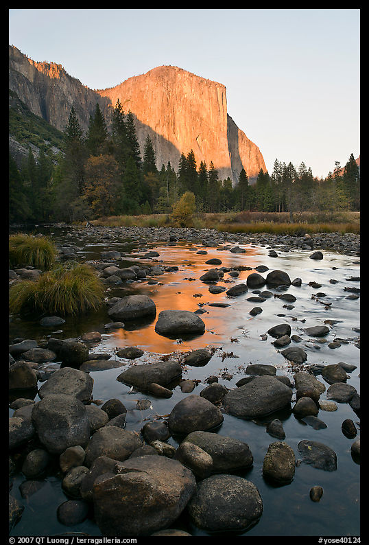 Boulders in Merced River and El Capitan at sunset. Yosemite National Park, California, USA.