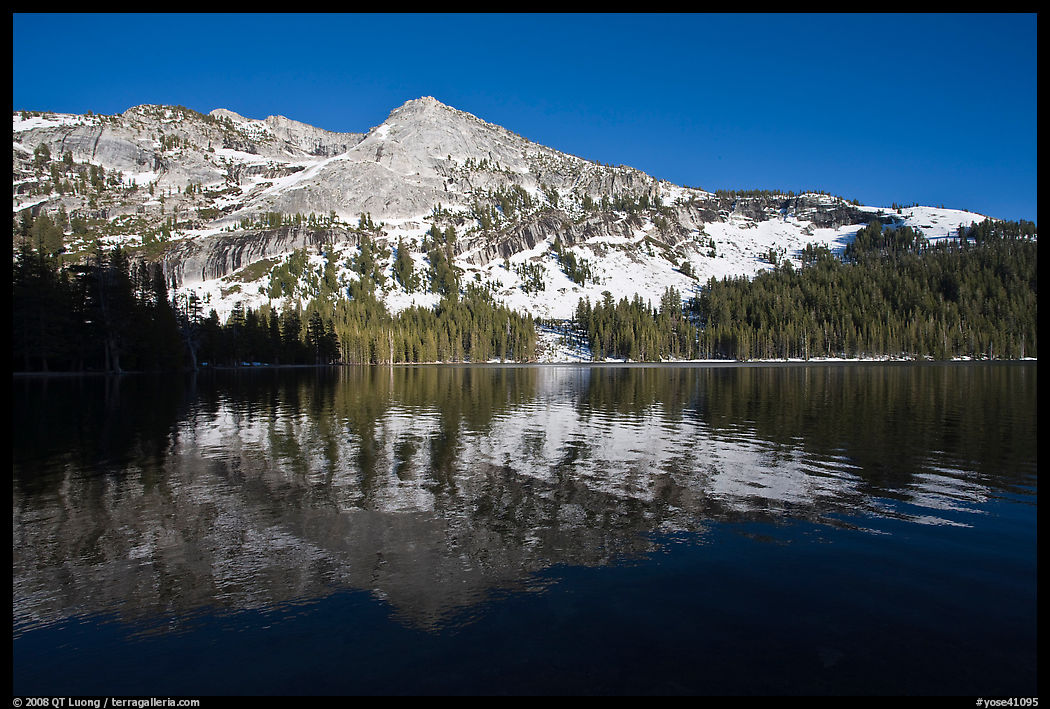 Tenaya Lake, with partly snow-covered peak reflected. Yosemite National Park