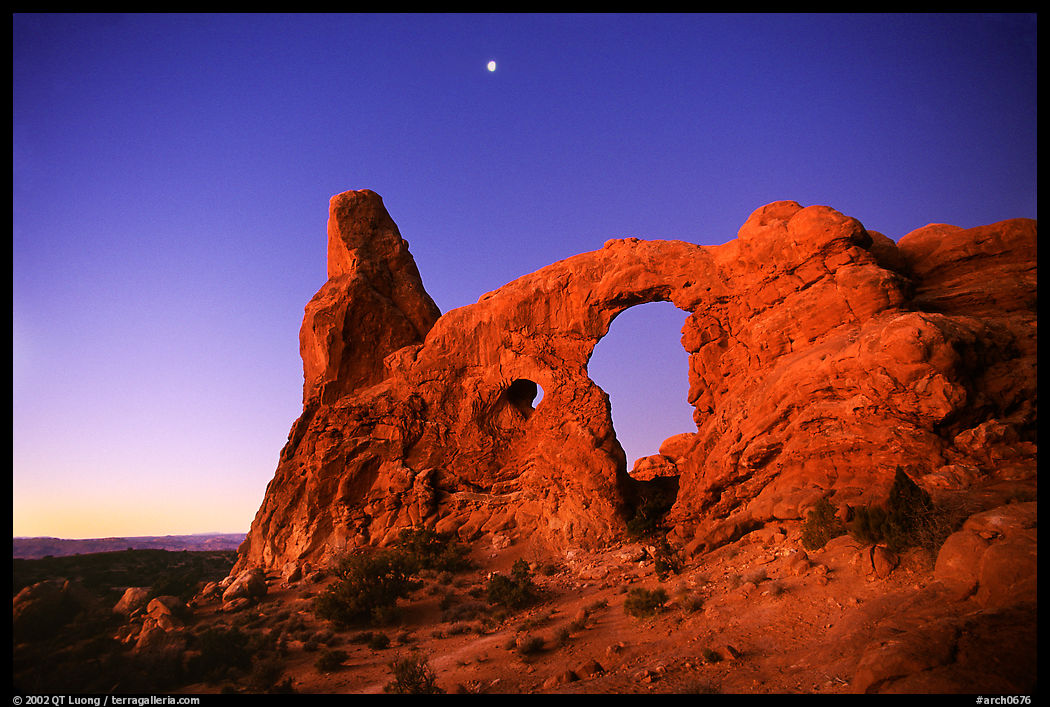 Turret Arch and moon, dawn. Arches National Park, Utah, USA.