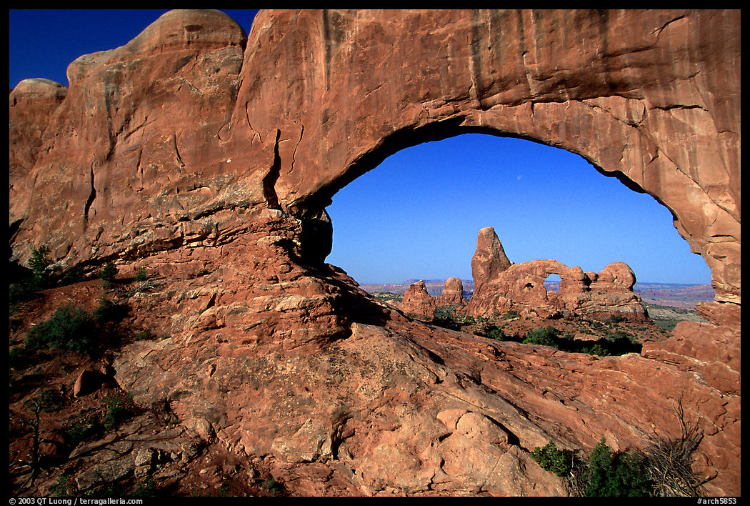 Turret Arch seen through South Window, early morning. Arches National Park, Utah, USA.