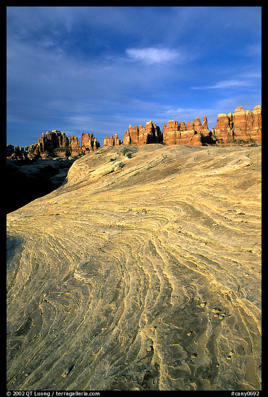Sandstone striations and Needles near Elephant Hill, sunrise. Canyonlands National Park, Utah, USA.