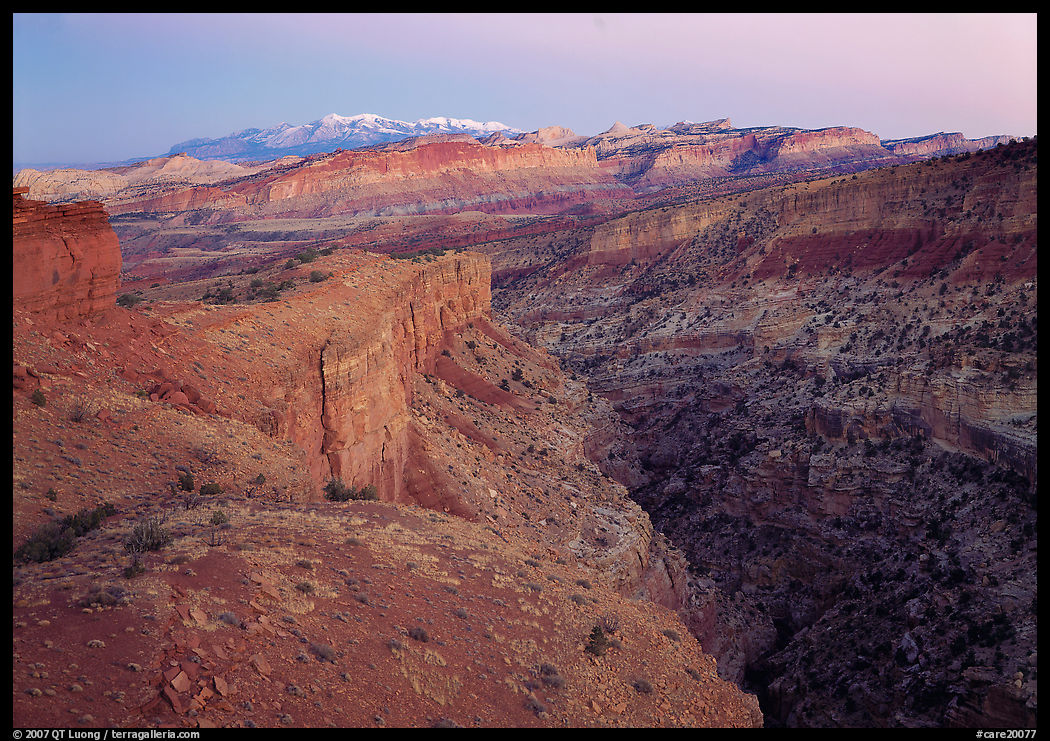 Waterpocket Fold and snowy mountains at dusk. Capitol Reef National Park, Utah, USA.