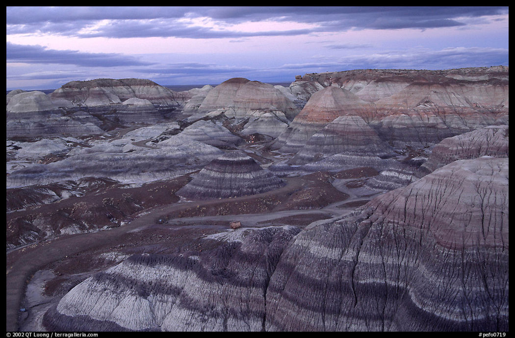 Multi-hued badlands of Blue Mesa, sunset. Petrified Forest National Park, Arizona, USA.