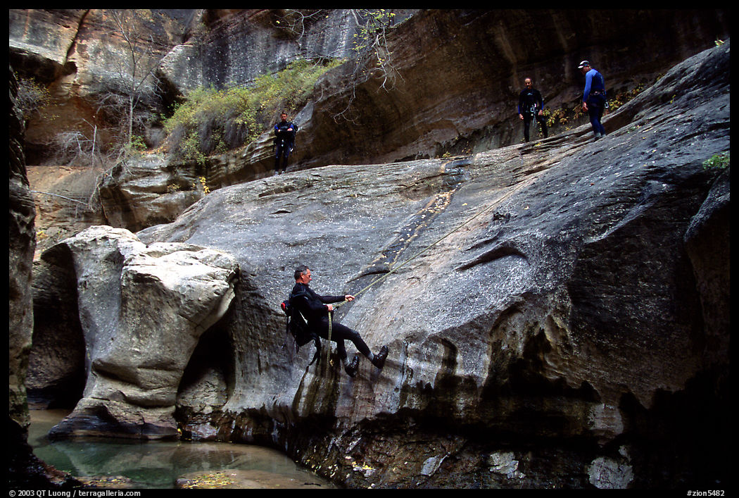 Canyoneers in wetsuits rappel down walls of the Subway. Zion National Park, Utah, USA.