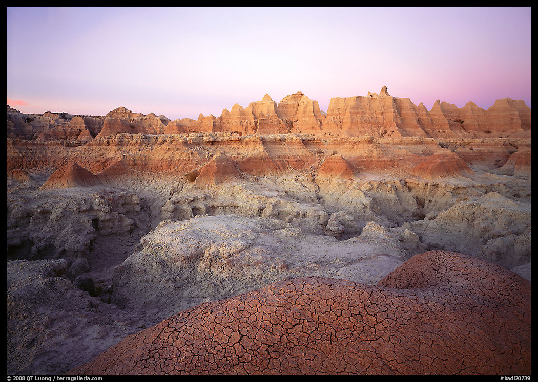 Cracked mudstone and eroded towers near Cedar Pass, dawn. Badlands National Park, South Dakota, USA.