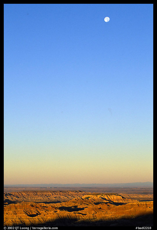 Sky, moon and badlands, sunrise. Badlands National Park, South Dakota, USA.