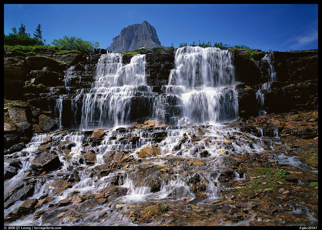 Waterfall at hanging gardens, with top of Mountain. Glacier National Park, Montana, USA.