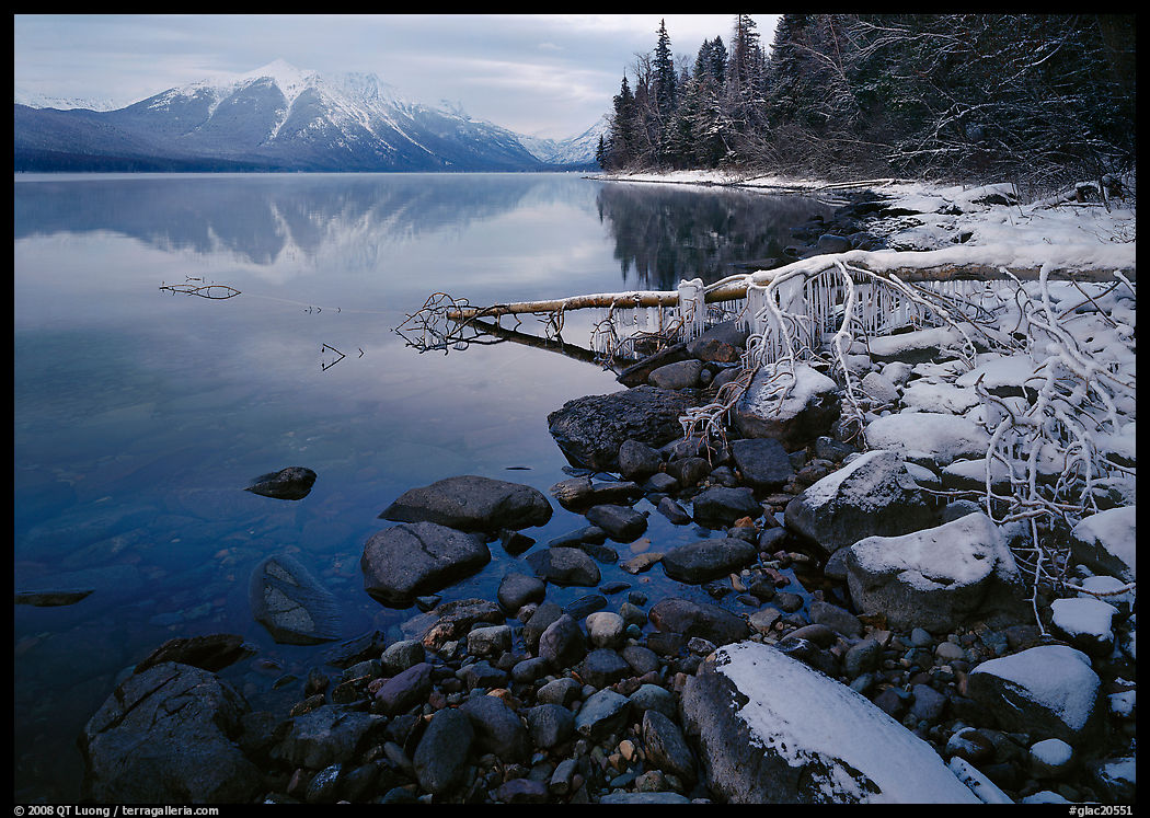 Snowy shoreline of Lake Mc Donald in winter. Glacier National Park