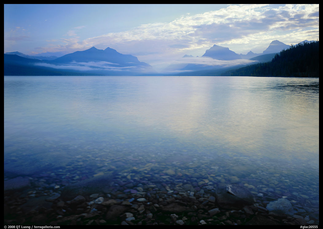 Lake McDonald with clouds and mountains reflected in early morning. Glacier National Park, Montana, USA.