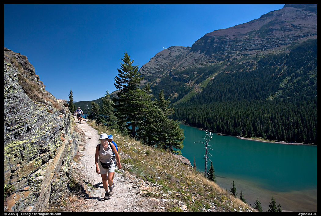 Hikers on trail above Lake Josephine. Glacier National Park, Montana, USA.